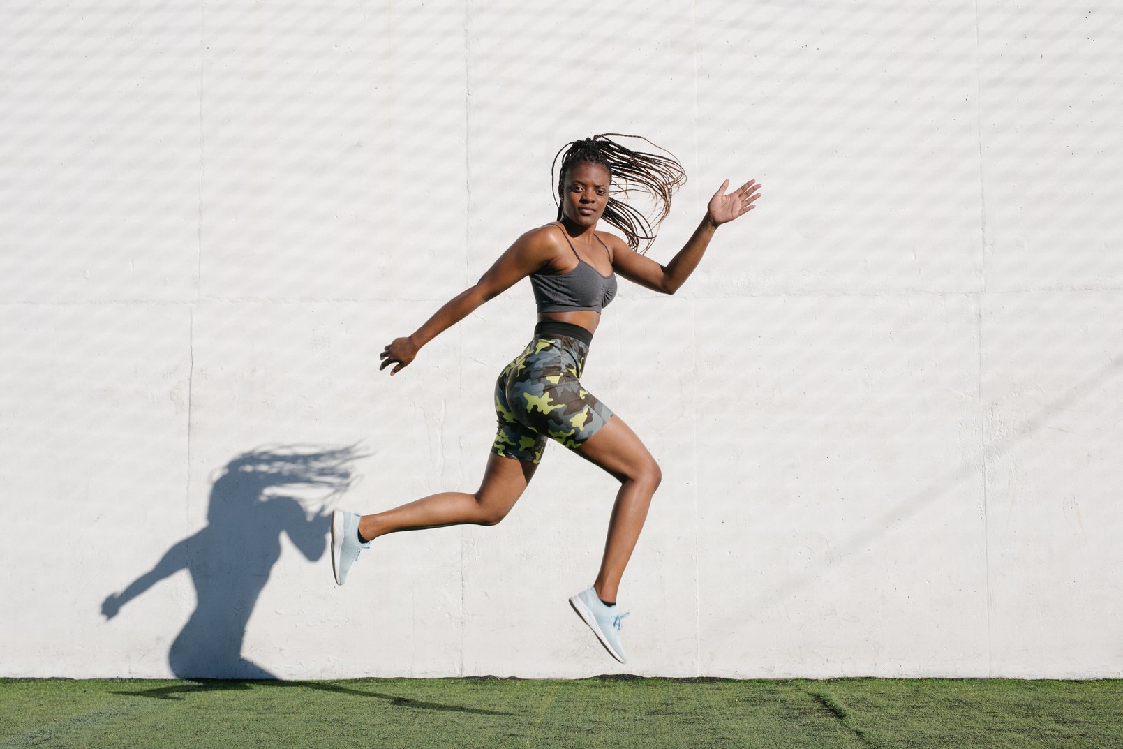 Diverse Woman in Sportswear Jumping Outdoors